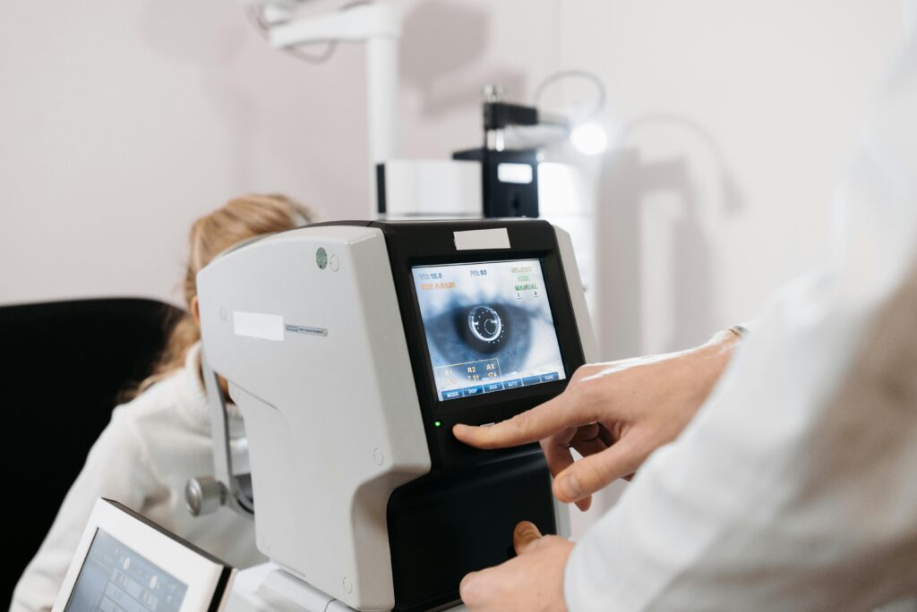 doctor looking at the eye of a patient on a piece of optometry equipment.